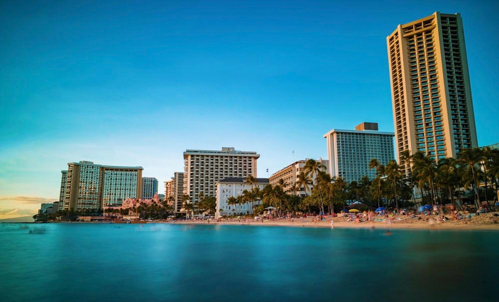 A photo shot from the ocean of condos lining Waikiki as the sun sets